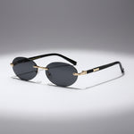 Sunglasses with black lenses and gold frames on a white background
