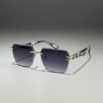 Sunglasses with gold accents on a light surface, with a cup and saucer in the background.