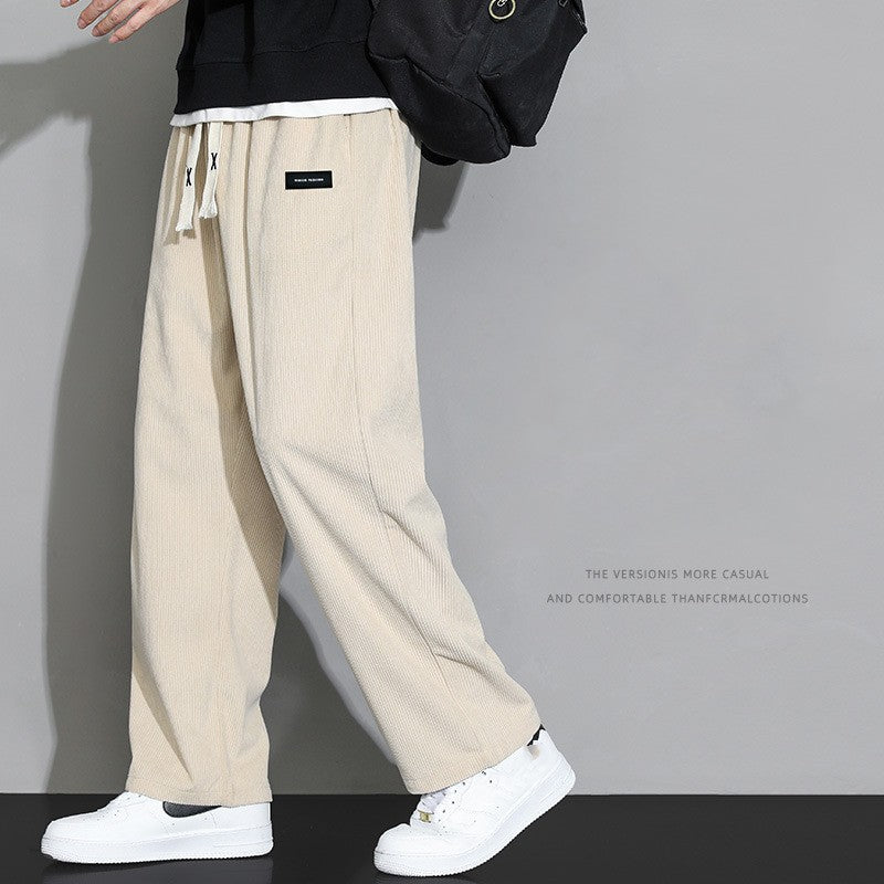 Men wearing loose casual wide-leg corduroy trousers in Black, Gray, and Khaki